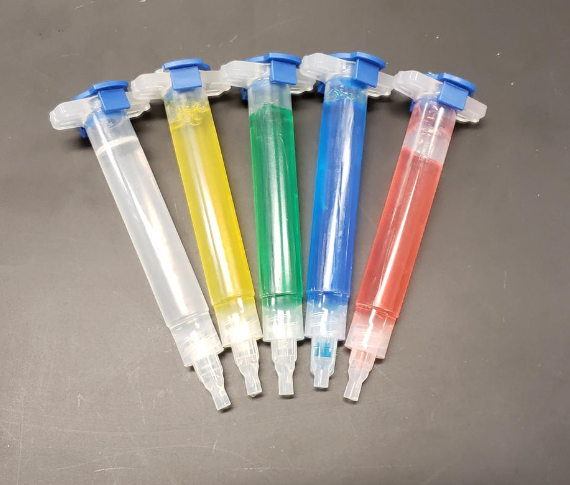 5 syringes of Pluronic hydrogel in varying colors (clear, yellow, green, blue, red)
